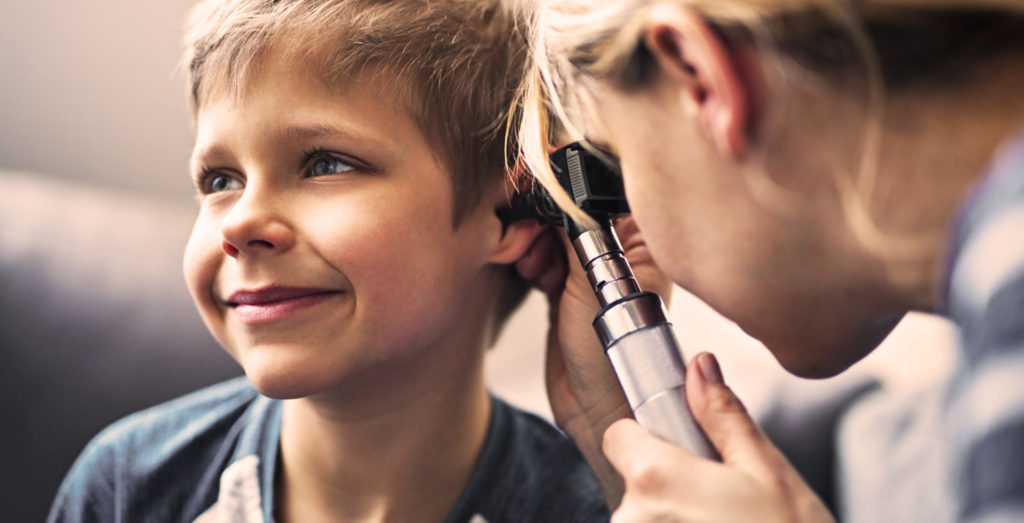 Evolve ENT Specialist examines boys ear