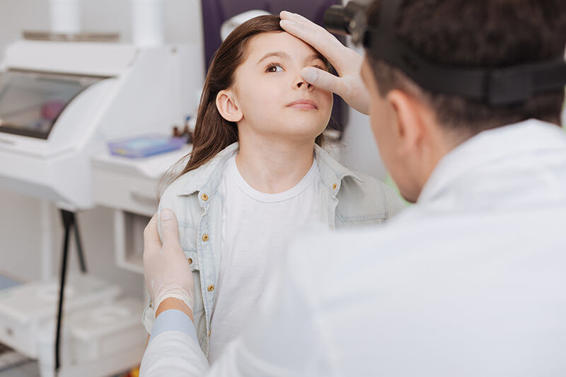 Nose Surgeon examining a child's nose
