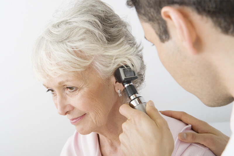 ENT Specialist using a Otoscope to look for ear drum damage